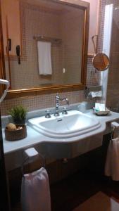 a bathroom with a white sink and a mirror at Pazo de Bendoiro in Bendoiro
