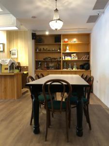 a dining room with a table and chairs at Yoshi Hotel in Tainan