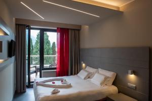 a hotel room with a bed and a large window at Hotel Griso Collection in Malgrate