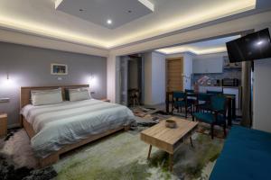 a bedroom with a bed and a dining room at Ririka Athens Homes - Cosy Apartments in Monastiraki, Athens Historical Centre in Athens