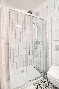 a bathroom with a shower and a toilet at City Life Apartments Kraków in Kraków