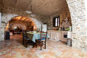 a kitchen with a table and chairs in a room at Dimora Pietrantica in Rocca Imperiale