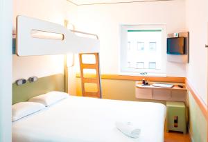 a hospital room with a bed and a window at ibis budget London Hounslow in Hounslow