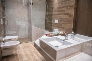 a bathroom with a sink and a toilet and a shower at AmbientHotels Panoramic in Rimini