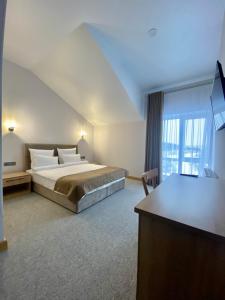 a hotel room with a bed and a desk at Balka Eco Club in Glubokaya Balka