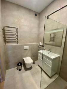 a bathroom with a toilet and a glass shower at Balka Eco Club in Glubokaya Balka