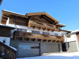 a house with a balcony and a garage at Apartment in Kaprun near the ski area in Kaprun