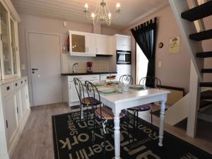 a small kitchen with a white table and chairs at Holiday Home in Bredene Terrace Fenced Garden in Bredene