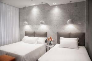 two beds sitting next to each other in a room at AmbientHotels Panoramic in Rimini +37 photos