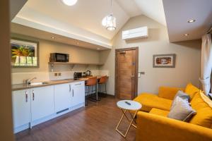 a living room with a couch and a kitchen at Bond Street Apartments in Wolverhampton