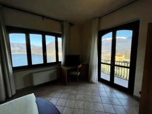 a room with two windows and a desk with a view at Locanda La Pernice in Sulzano