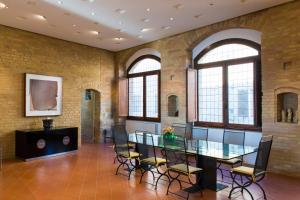 a large room with a glass table and chairs at Zafferano Rooftop Terrace Tower House in San Gimignano