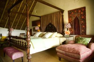 a bedroom with a canopy bed and a chair at Olepangi Farm in Nanyuki