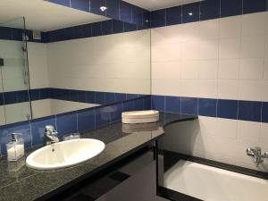 a bathroom with a sink and a mirror at MATILLA - Apartamento con parquin in Cadaqués +15 photos