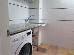 a laundry room with a washing machine and a counter at MATILLA - Apartamento con parquin in Cadaqués