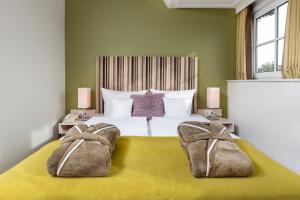 Postel nebo postele na pokoji v ubytování Hotel und Spa Lundenbergsand