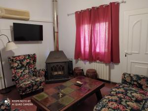 a living room with a table and a fireplace at la felicidad de la tierra in Torija