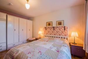 a bedroom with a large bed and two lamps at Chiemgau Idyll in Bergen