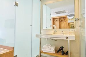 a bathroom with a sink and a mirror at El Puerto Ibiza Hotel Spa in Ibiza Town