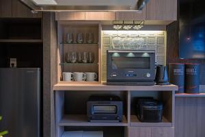 a cabinet with a tv and a computer on a shelf at trive sakae 最大7名宿泊可能 矢場町駅徒歩3分 栄 大須観音スグ in Nagoya