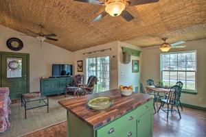 a kitchen with an island in a room with a table at Quaint Countryside Casita 45 Mi to Ft Worth in Buckner