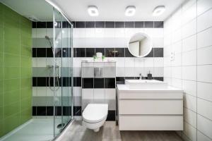 a bathroom with a toilet and a sink and a shower at BpR Astro Studio Home in Budapest