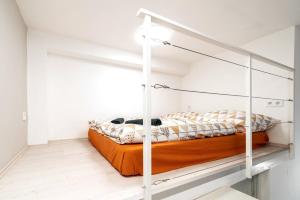 a bedroom with a bunk bed with an orange mattress at BpR Astro Studio Home in Budapest