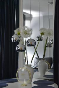 trzy wazy z kwiatami na stole w obiekcie Warszawska Apartament Rajgród w Rajgrodzie