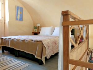 a bedroom with a large bed with a wooden ladder at To The Garden in Aliki