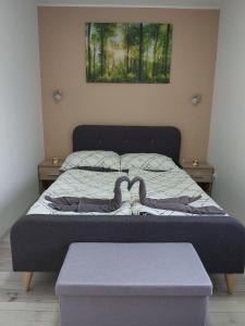 A bed or beds in a room at Bakonybél Nefelejcs Vendégház