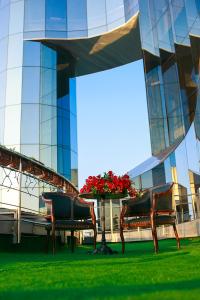 a park bench in front of a large building at Boutique Spa Casino Hotel Lybid Plaza in Khmelnytskyi