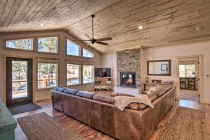 a large living room with a couch and a fireplace at Quiet Mtn Cabin with Deck Less Than 5 Mi to Fairplay Beach! in Fairplay