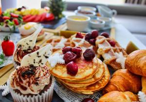 a table with a bunch of pastries and croissants at Rila Hotel Borovets in Borovets