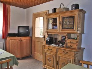 a room with a large wooden cabinet and a tv at Haus Zaineck in Anger