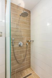 a shower with a hose in a bathroom at Nana Angela Apartments in Hersonissos