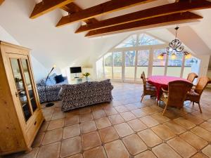 a living room with a table and a couch at Villa Caprivi - 12 in Heringsdorf