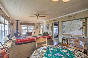 a living room with a table and a map on the wall at Downtown Cabin Less Than 10 Miles to Mt Shasta Ski Park! in McCloud