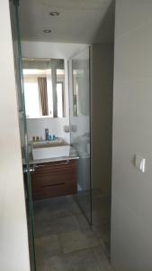 a bathroom with a sink and a mirror at Neopol Hotel in Kuşadası