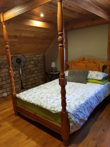 a bedroom with a four poster bed in a attic at Loeriehuis in George