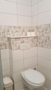 a white bathroom with a toilet and a sink at Apartments Mateljan 1715 in Kaštela +38 photos