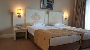 A bed or beds in a room at Crystal Admiral Resort Suites & Spa - Ultimate All Inclusive