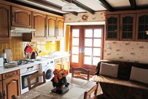 a kitchen with a table and a stove top oven at La Cascade Fleurie in Saint-Genès-Champespe