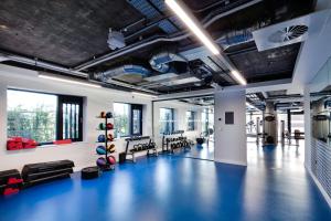 a gym with a blue floor and chairs in it at Highfield House Apartments in Dublin