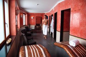 a man walking down a corridor in a hotel room at Sport & Wellnesshotel San Gian St. Moritz in St. Moritz