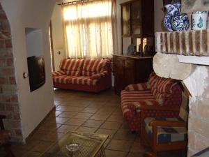 a living room with two couches and a tv at Cuevas Rio Baza in Baza
