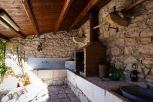 a kitchen with a brick wall with a brick oven at Kaary Country in Santa Croce Camerina +44 photos