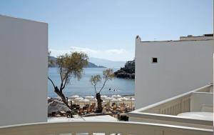a view of a beach from the balcony of a building at Thomais Studios in Naxos Chora