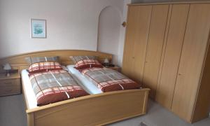 una camera con un letto con due cuscini rossi di Haus Spiegel a Hilders