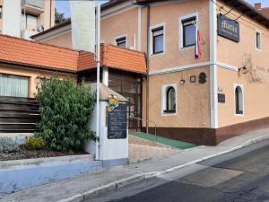 a building with a sign on the side of a street at Apartments at Gostilna Martin in Trbovlje