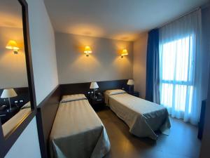 Postel nebo postele na pokoji v ubytování Hotel Le Badie
